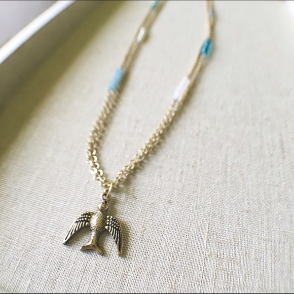 Long gold WHBM necklace with bird pendant