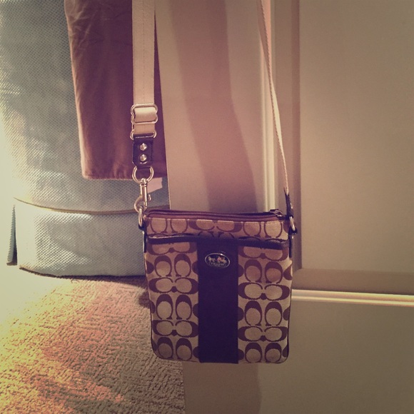 A brown coach cross body purse