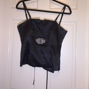 Black sheen top with appliqué and lace-up back