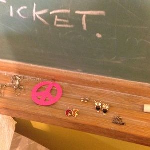 Four pairs of earrings and a peace sign necklace