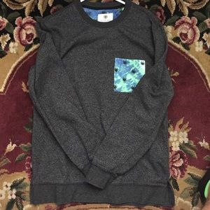 Gray sweater with tie dye pocket. Weed leaves