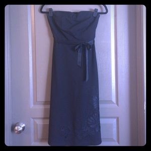 Black strapless cocktail dress with embroidery.