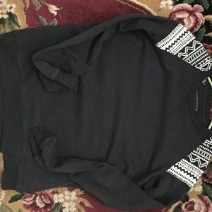 Black crew neck with tribal design on shoulders