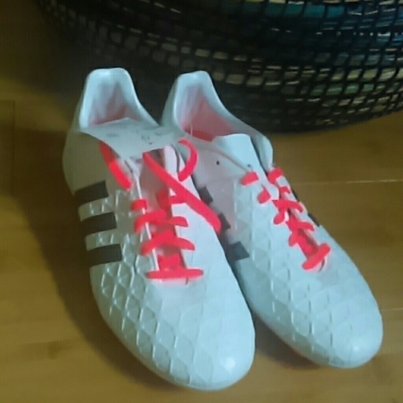 Adidas white cleats with neon orange laces