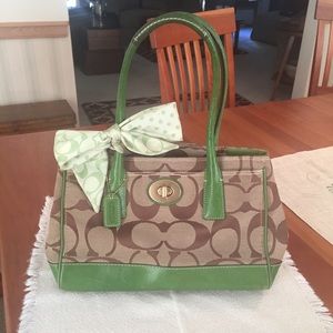 Classic coach purse with green accents and bow