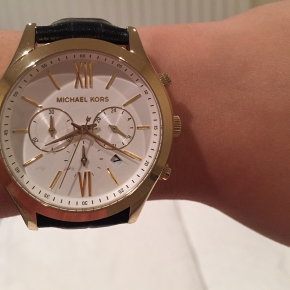 {Michael Kors} Gold tone black leather watch.