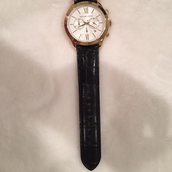 {Michael Kors} Gold tone black leather watch.