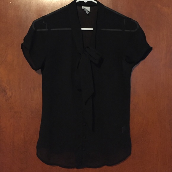 Sheer black cap-sleeved blouse.