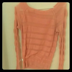 A dark peach to coral color top