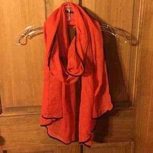 Bright orange scarf with black trim