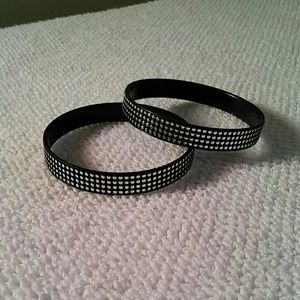 Two black and silver bracelets