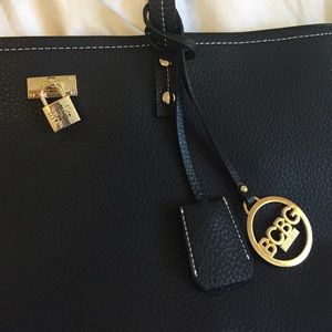 Brand New. Black BCBG tote with gold accents.