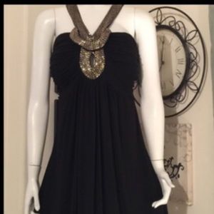 Black high/low dress with gold hardware
