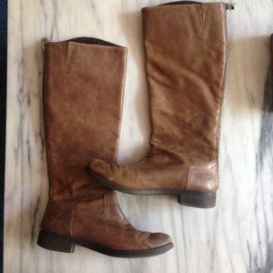 Brown leather riding boots.