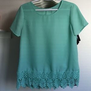 Sea foam green top with lace trim at the bottom