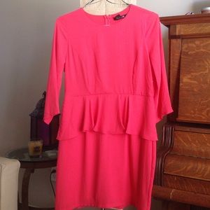 Large coral color peplum dress.