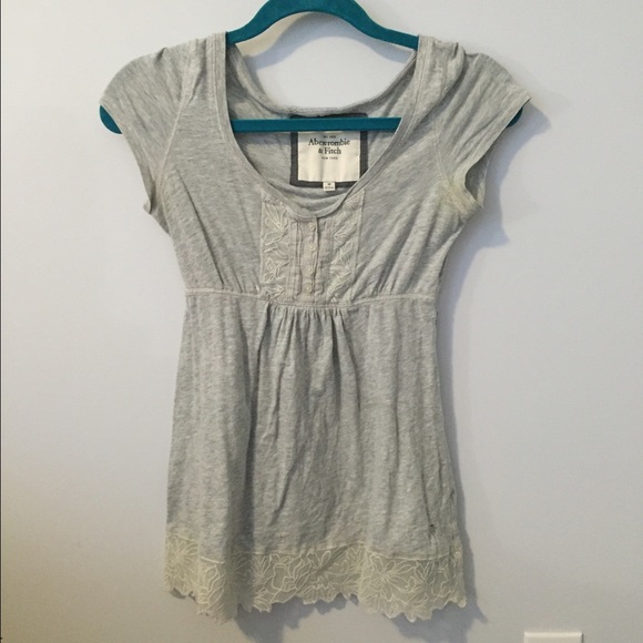 Gray flowy top with buttons and lace bottom detail