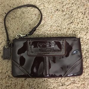 Coach patent leather maroon wristlet.