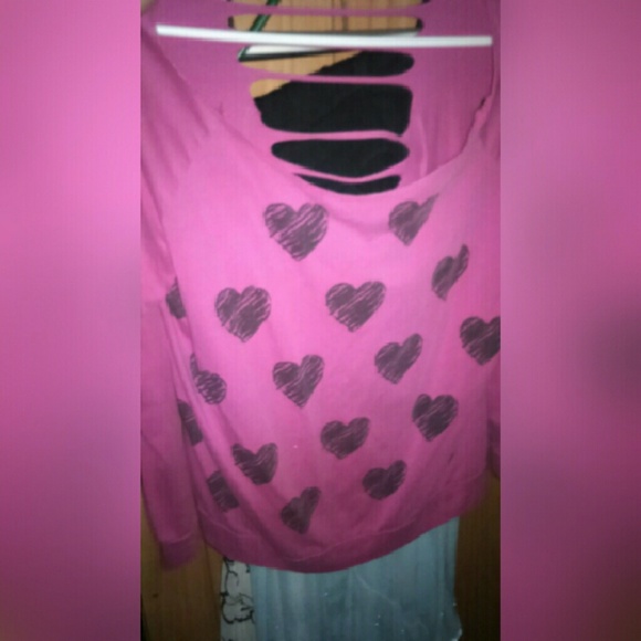 A pink shirt with back hearts.