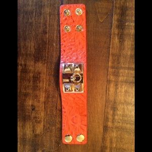 Orange bracelet with gold studs