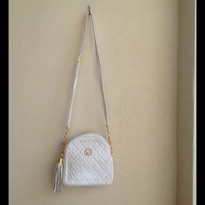 White St. John purse with tassels on the zipper.