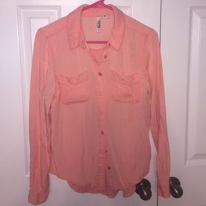 A coral button up blouse