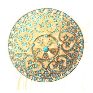 White, cap sleeve shirt with a turquoise medallion