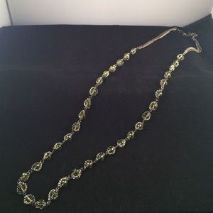 Long black necklace with green stones