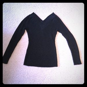 Sparkly black top with long sleeves.