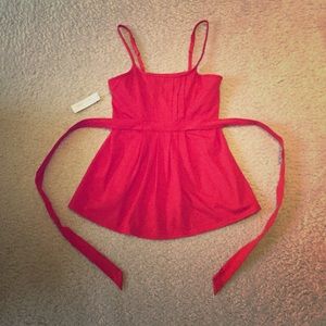 Red pleated top with spaghetti straps.