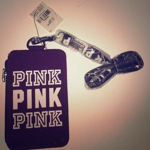PINK wallet/wristlet with lanyard attached.