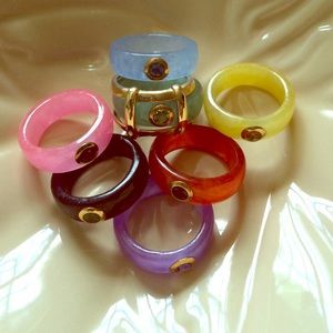 Jade ring set with gold tone ring jacket.