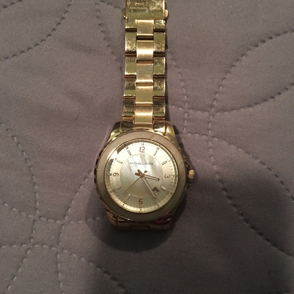 Gold oversized MIchael Kors watch.