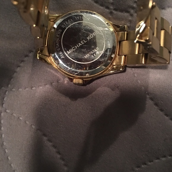 Gold oversized MIchael Kors watch.