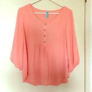 Coral blouse with gold buttons