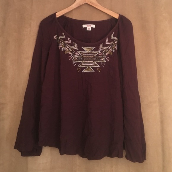 Long sleeve, maroon colored shirt with design.