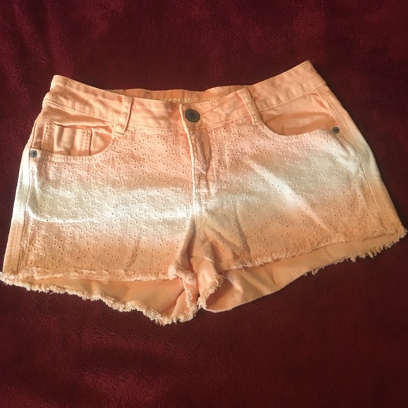 Orange cream colored jean shorts with design
