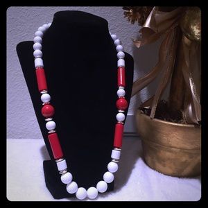 Long white and red necklace.