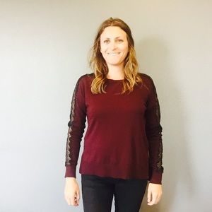 Burgundy sweater with lace detail along the sleeve