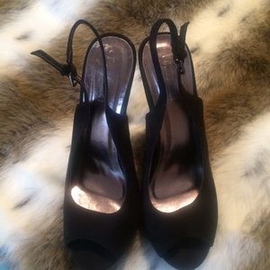 Black peep toe platforms with studded heels