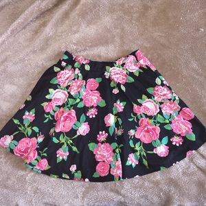 Pink and black with white and green floral skirt
