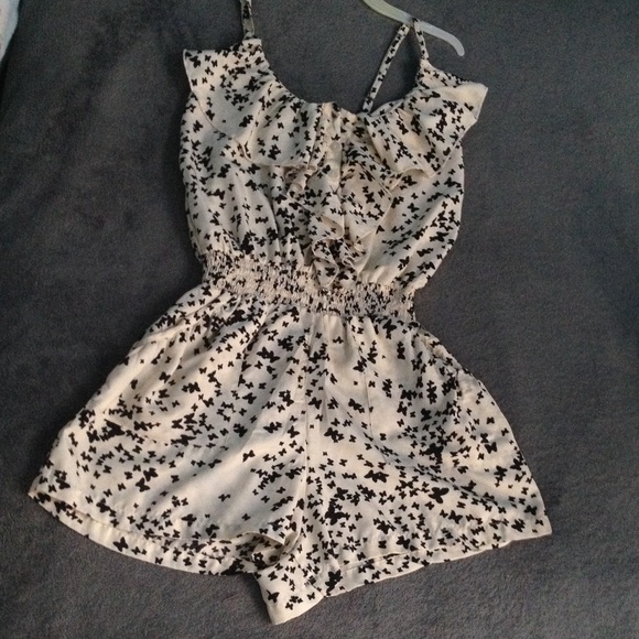 Cream colored romper with black butterfly pattern