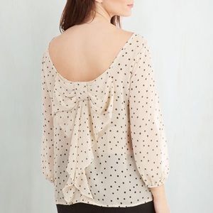 Reversible polka dot blouse.