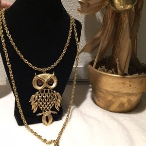 Golden owl with a very long chain.