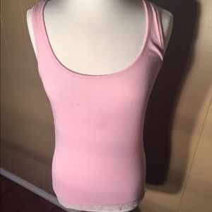 Light pink tank top with lace around the bottom.