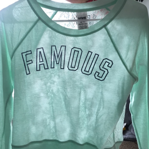 Teal long sleeve with writing looks new - Picture 2 of 3