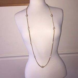 Long chain gold necklace.