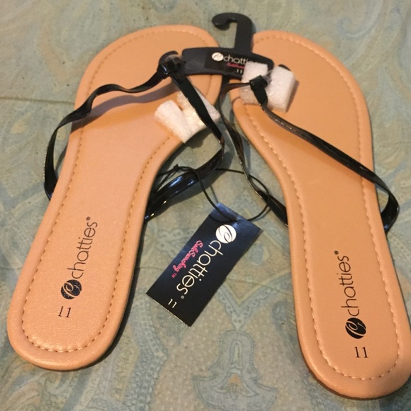 Tan with black foot string flip flop sandals. - Picture 1 of 1