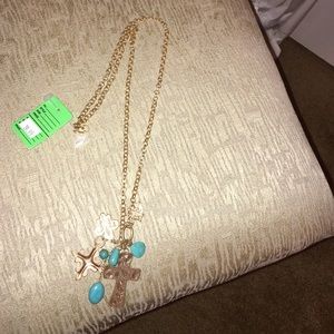 Long chained gold necklace with crosses