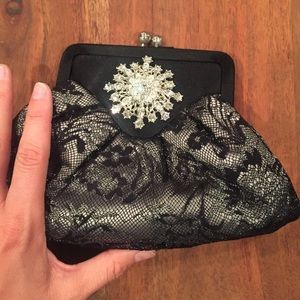 Black tie clutch with rhinestone embellishment